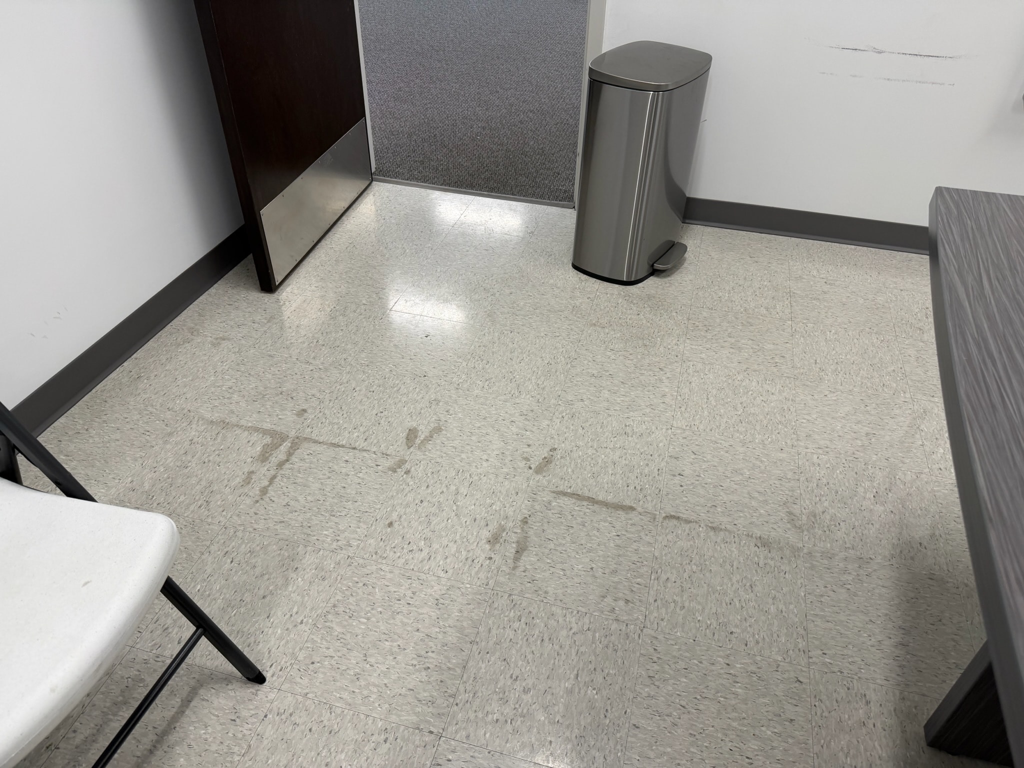 Stained commercial floor tiles before cleaning